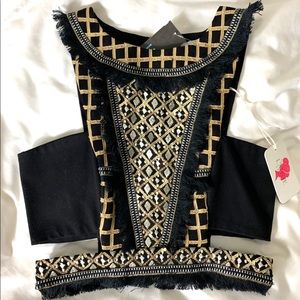 Cutout black and gold crop top.